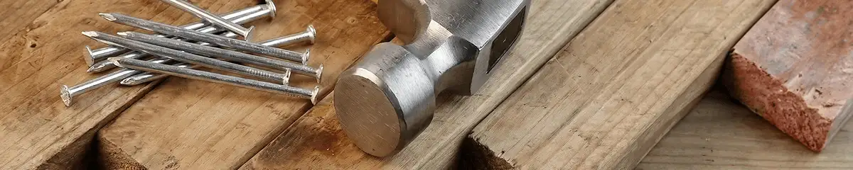 Hammer and nails on hardwood flooring boards in El Paso, TX